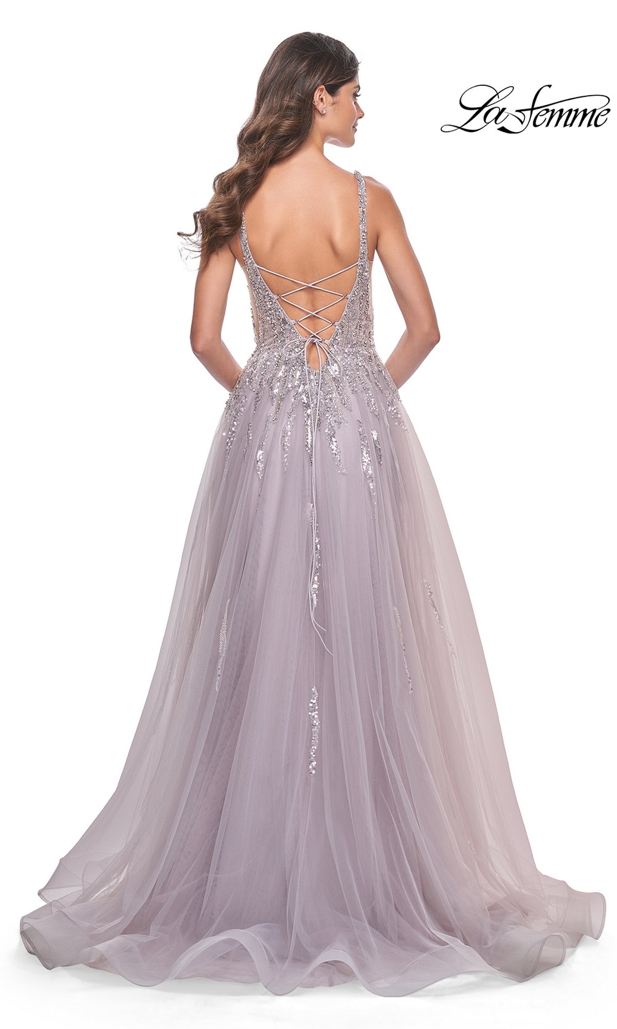 Woman wearing La Femme 31995, a sequined long mauve prom dress with jeweled accents, lace-up open back, and flowing tulle A-line skirt, shown from behind.